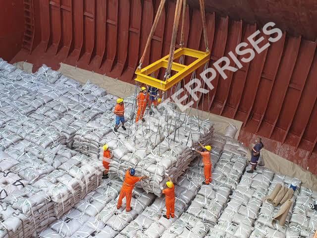 Bags of white ICUMSA 45 sugar from Brazil being loaded onto a ship for international delivery.